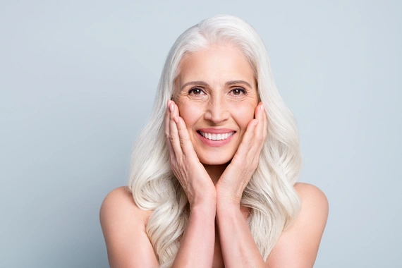 Woman smiling confidently after implant treatment